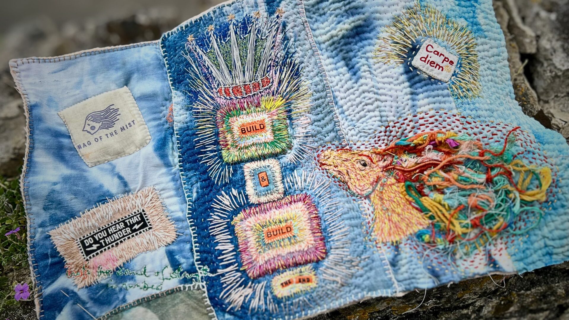 Colourful embroidered textile art piece.