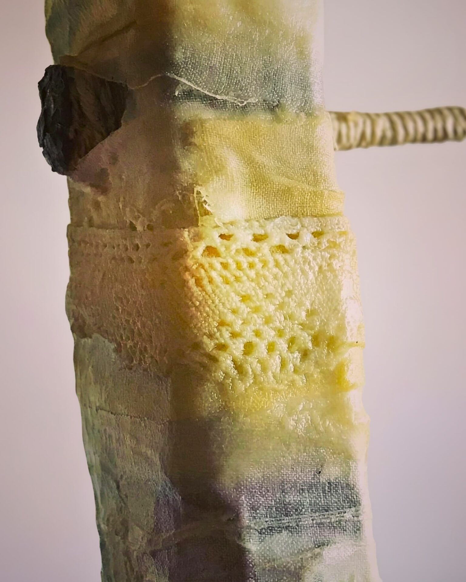 Textured fabric with intricate stitching details.