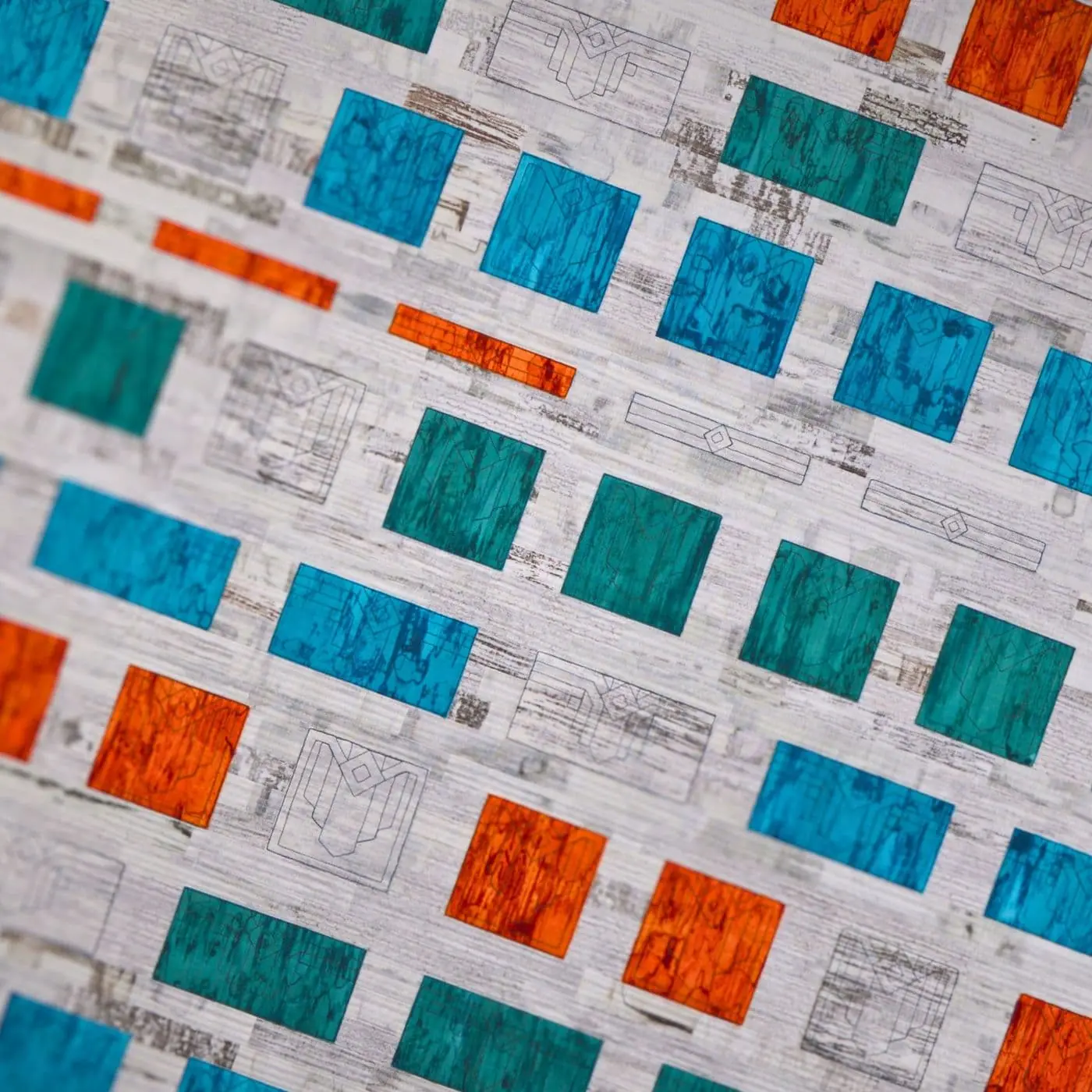 Close up of printing, dying and machine stitching on fabric.