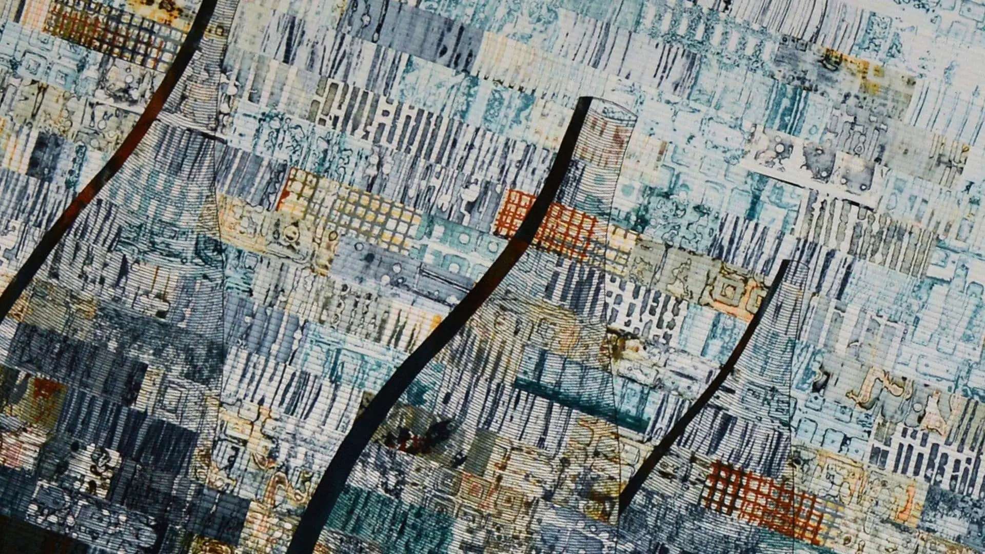 a close up of printing, applique and machine stitching on cotton fabric