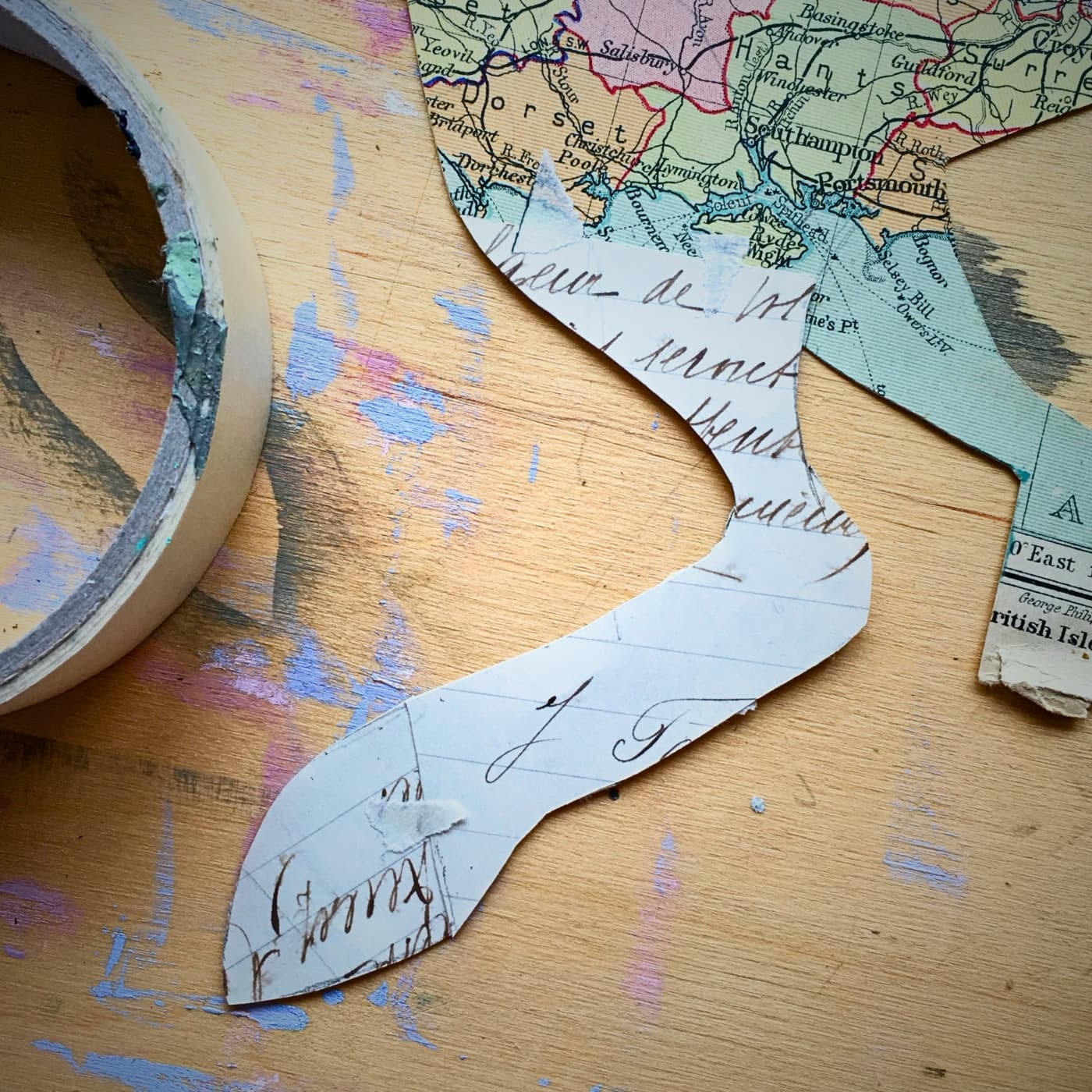 Collage in paper of rabbits paw, with a map elements