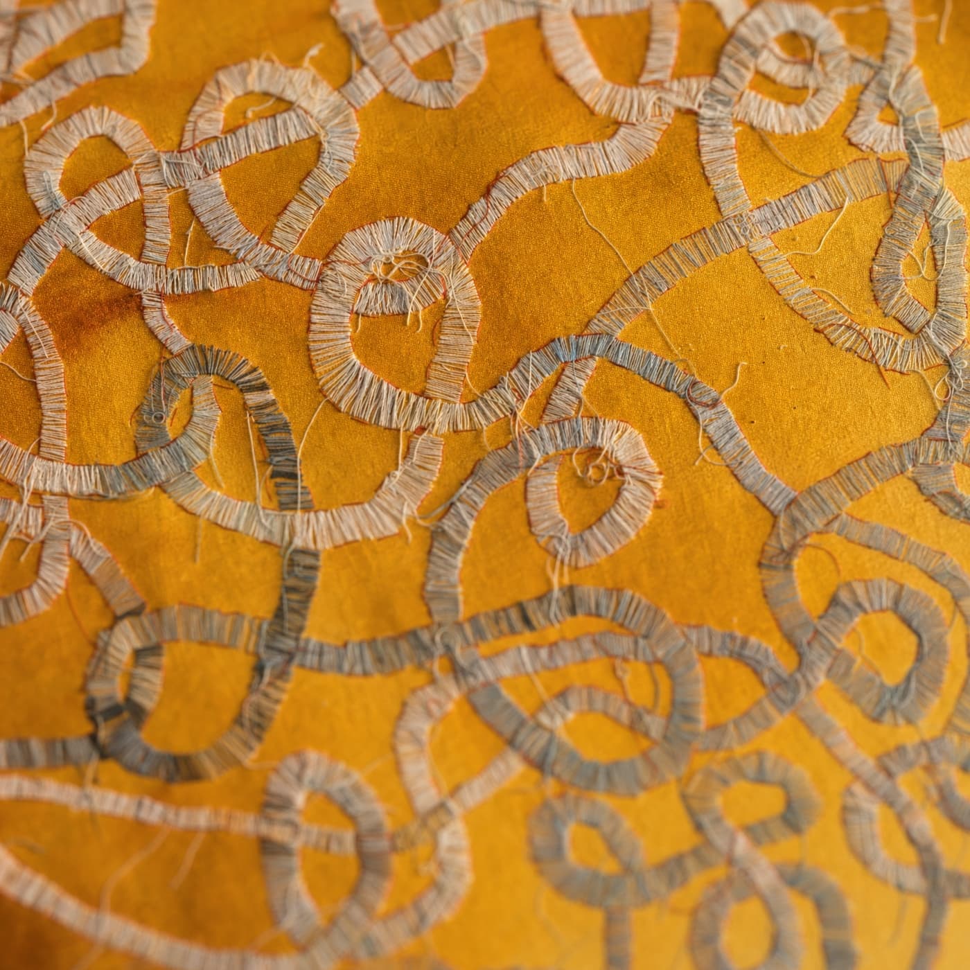 Intricate embroidery on golden fabric.