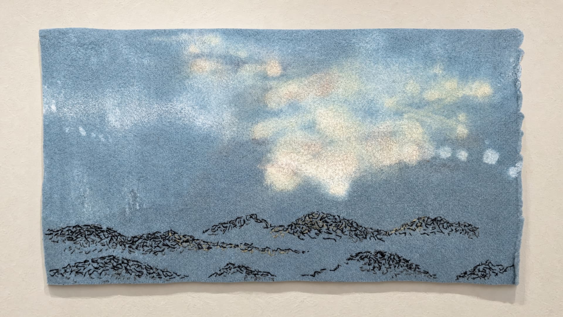Abstract textile landscape with soft blue tones.