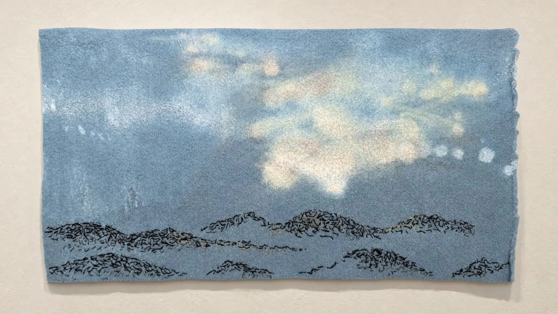 Abstract textile landscape with soft blue tones.