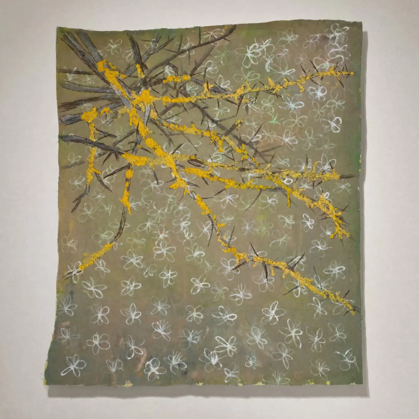 Textile art piece featuring branches with yellow against floral background