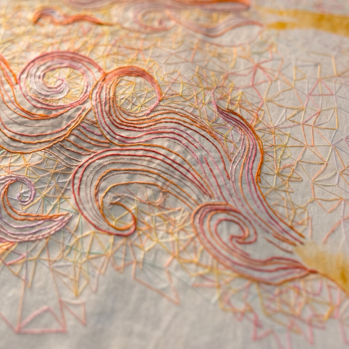 Intricate embroidery with swirling patterns.