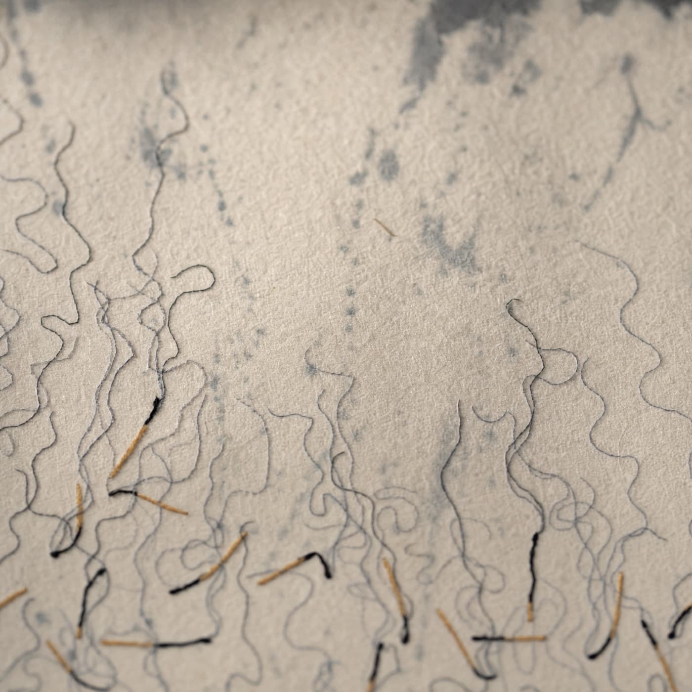 Textile art with abstract thread lines resembling smoke and rain.