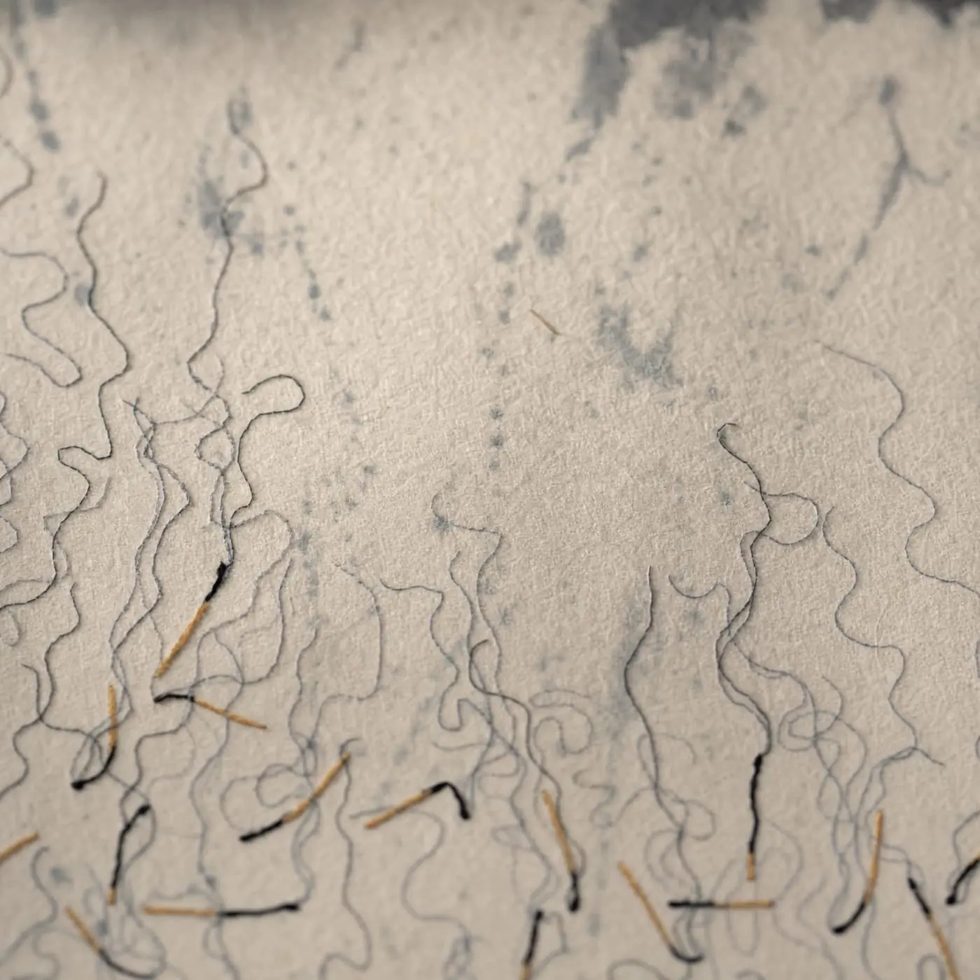 Textile art with abstract thread lines resembling smoke and rain.