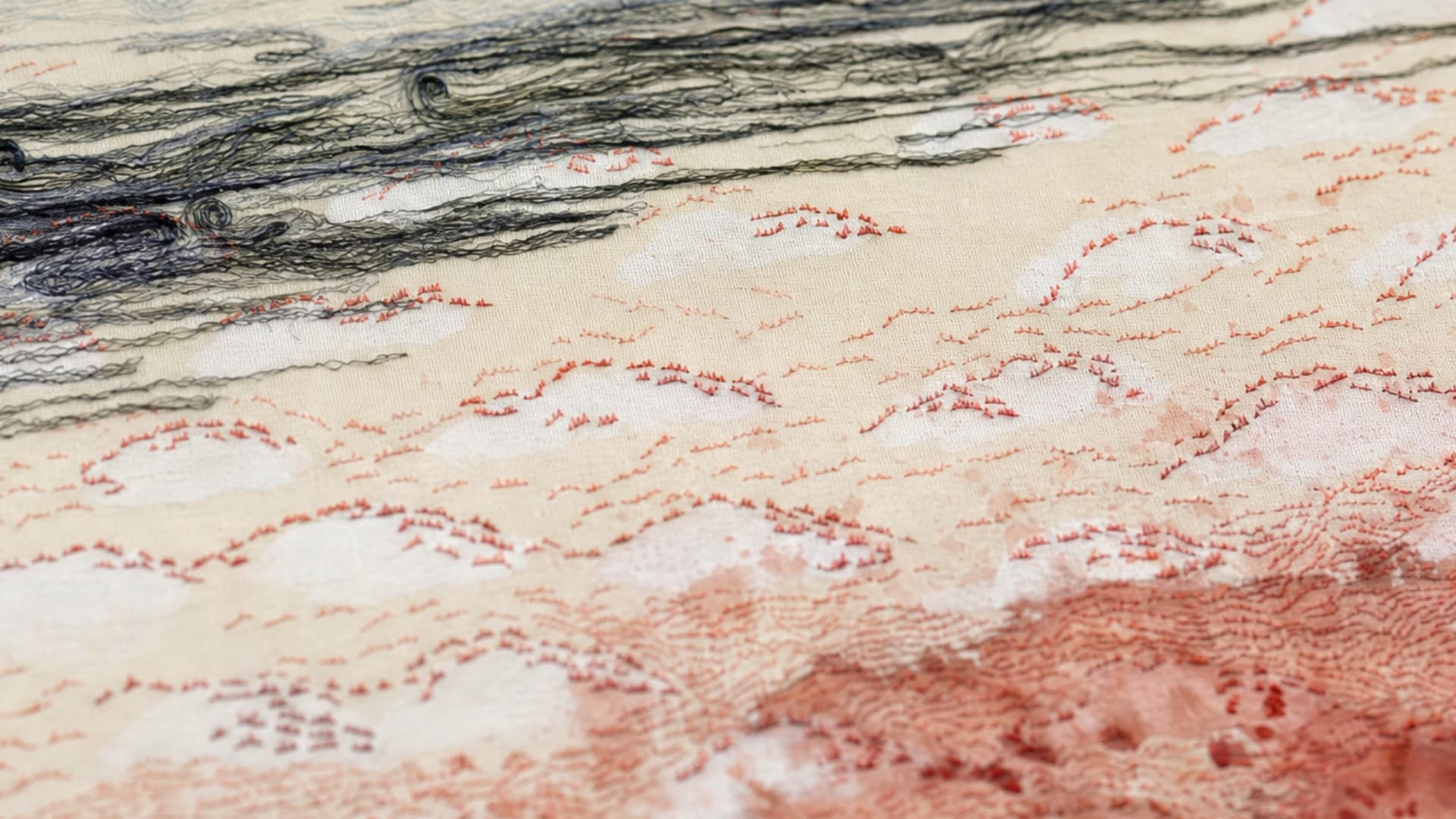 Intricate embroidery on textured fabric.