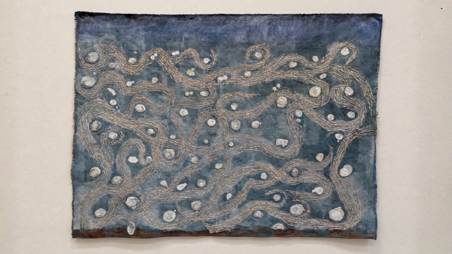 Abstract artwork with swirling patterns and textures.