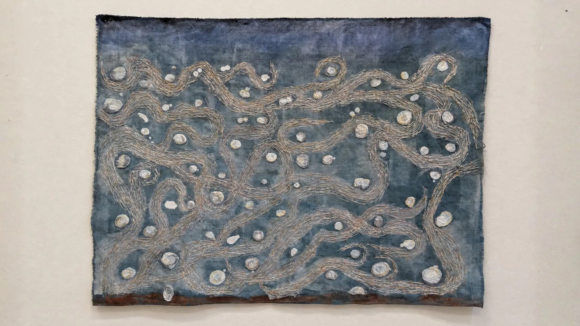 Abstract artwork with swirling patterns and textures.