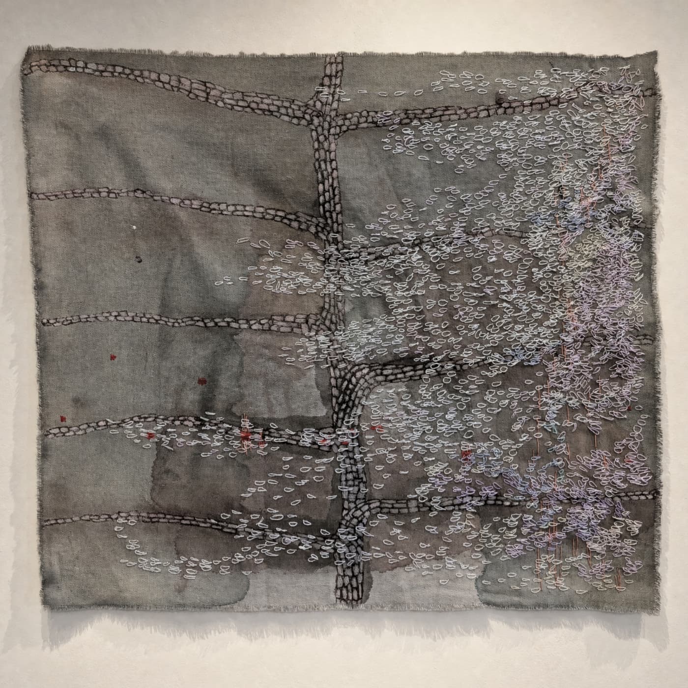 Textile artwork with intricate embroidery details.