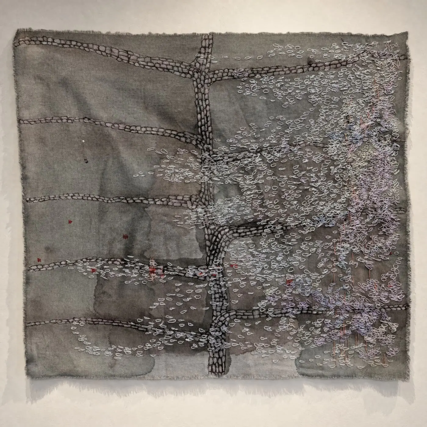 Textile artwork with intricate embroidery details.