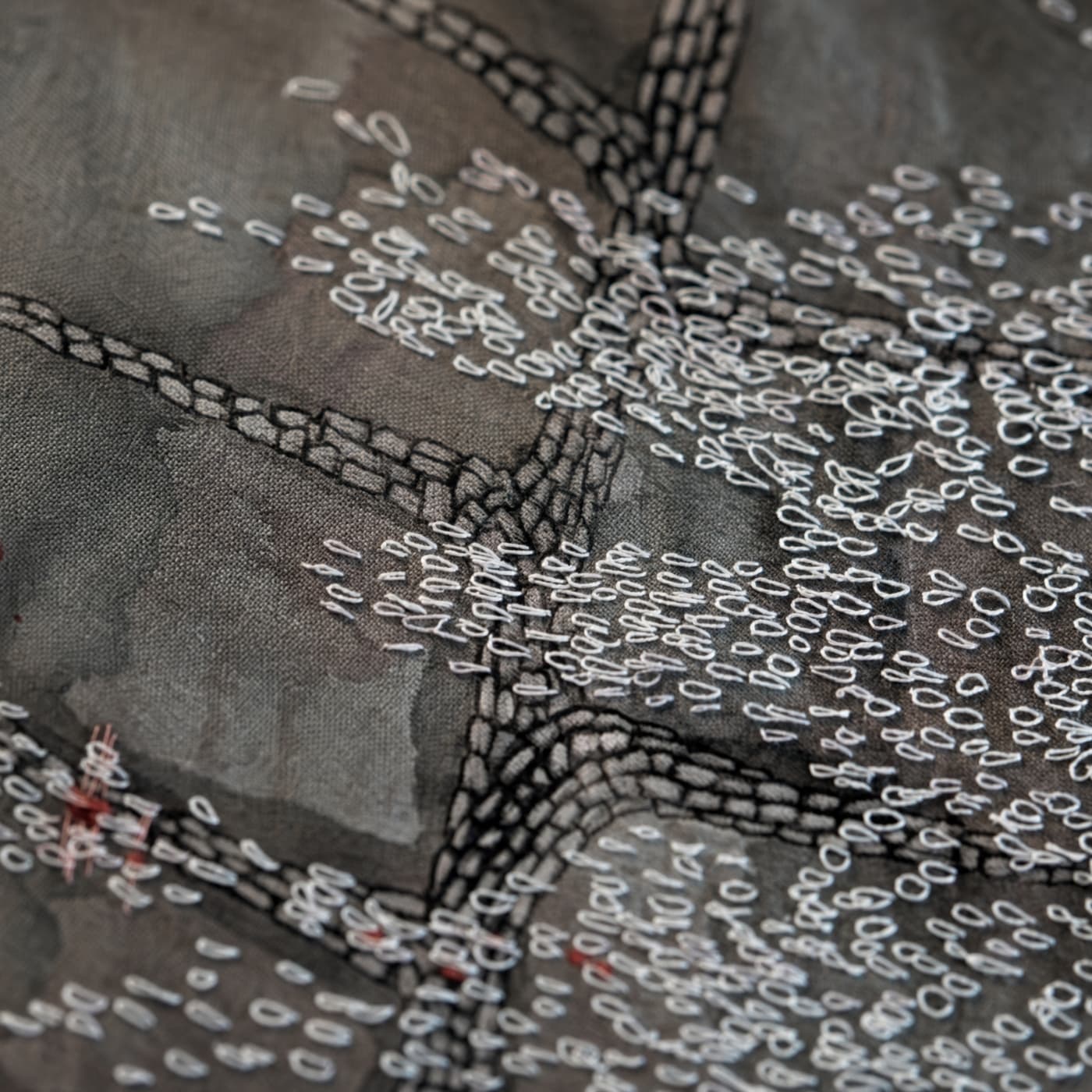 Intricate embroidery on textured fabric.