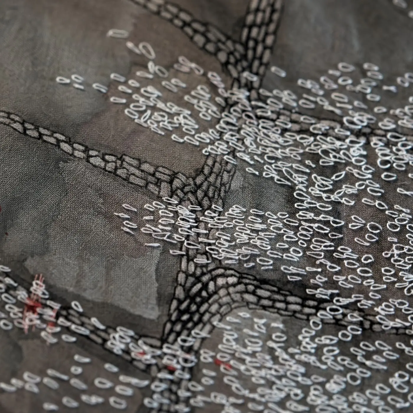 Intricate embroidery on textured fabric.