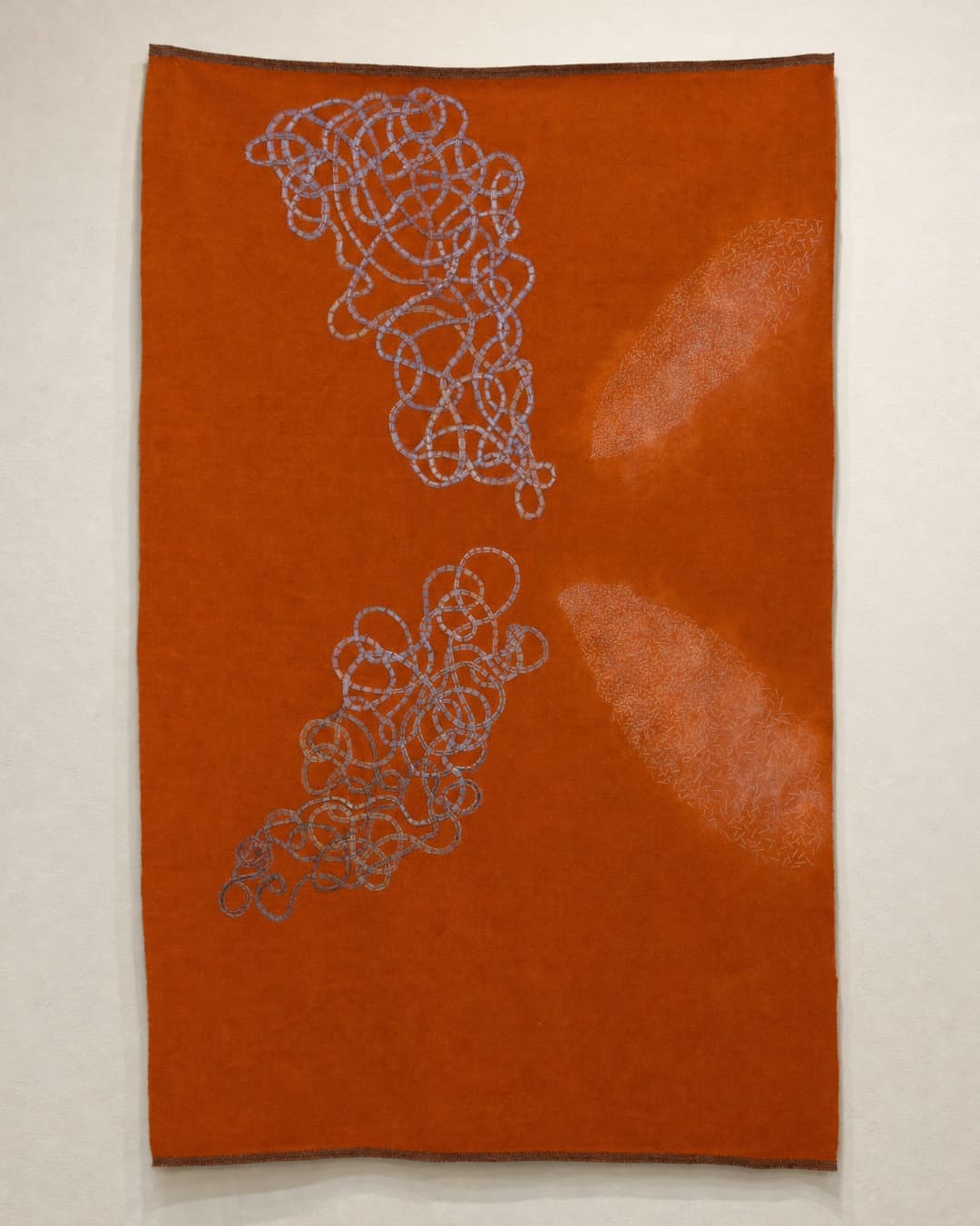 Abstract orange textile with blue patterns.