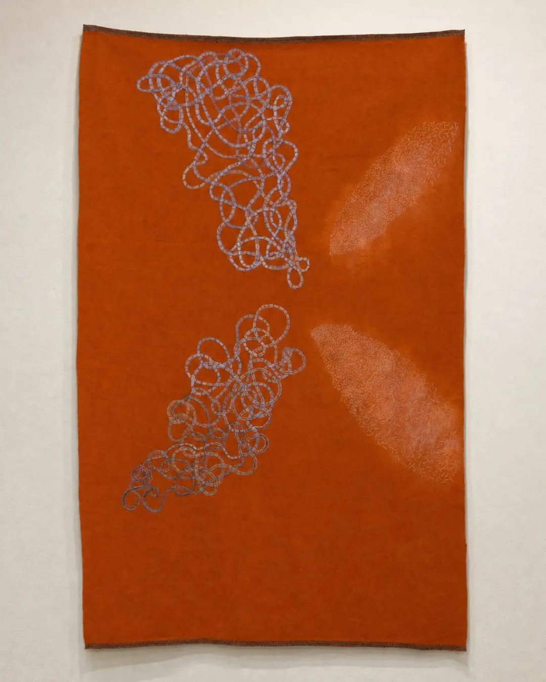 Abstract orange textile with blue patterns.