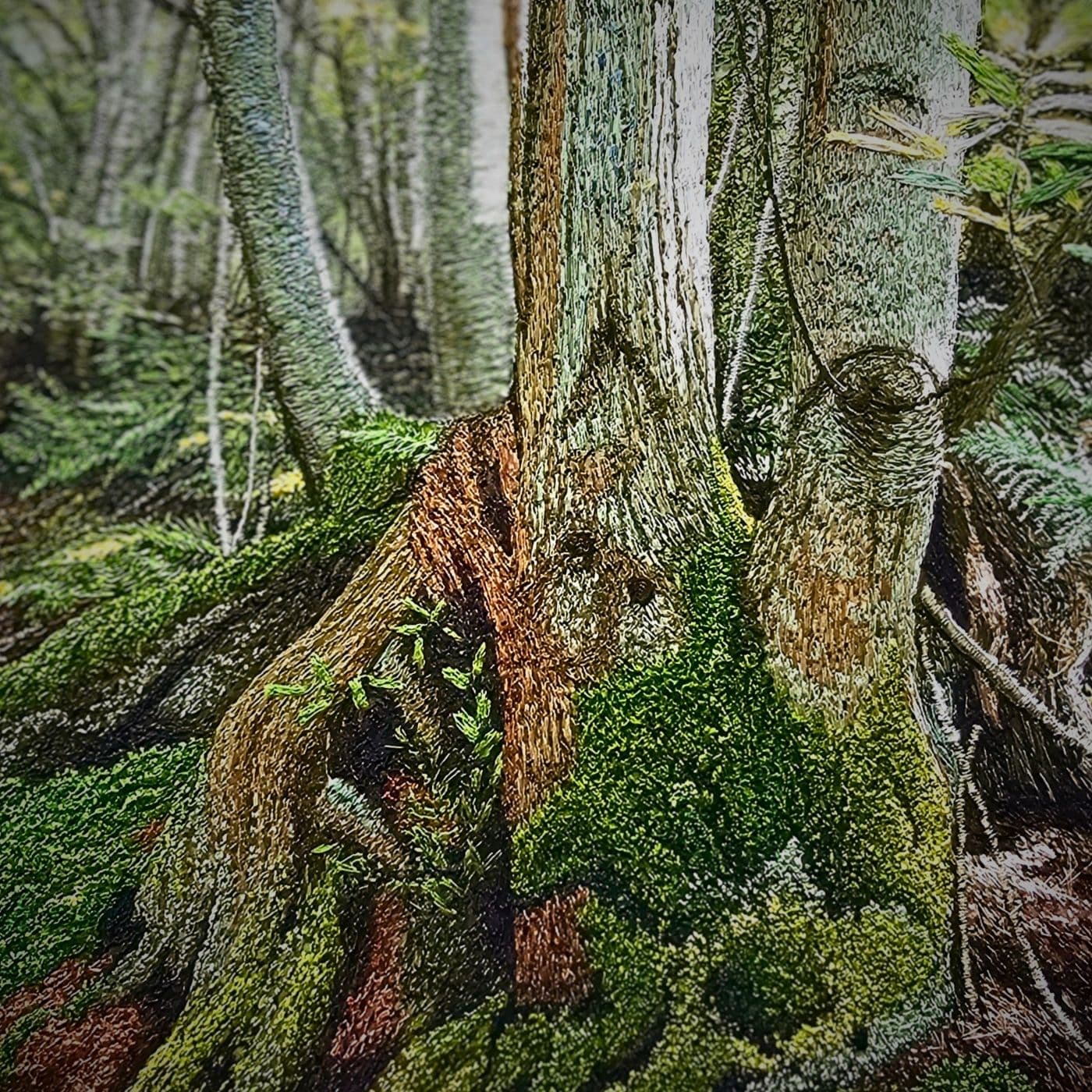 A machine embroidered piece of art showing tree trunk with moss growing on it
