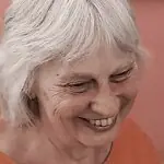Mandy Pattullo smiling warmly, reflecting her joy and expertise in the field of textile art