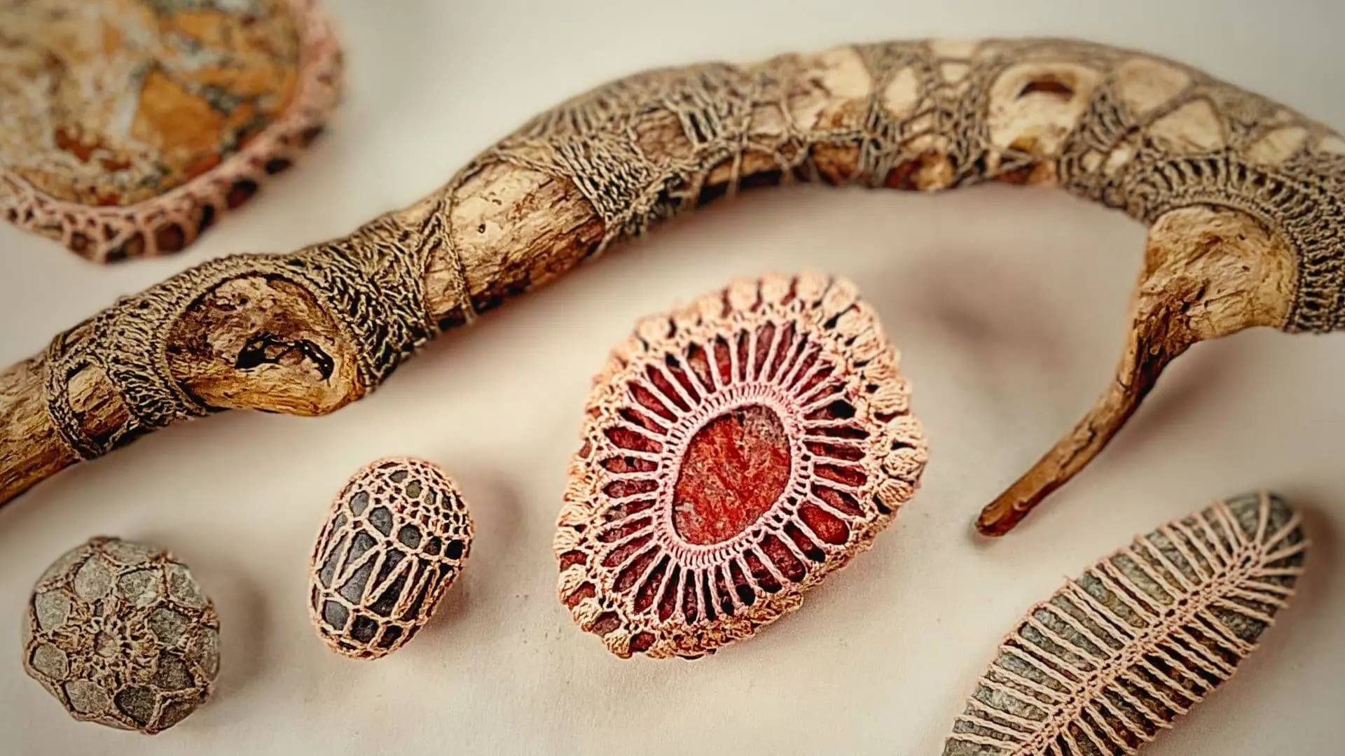 A group of objects with crocheted stitch art around them