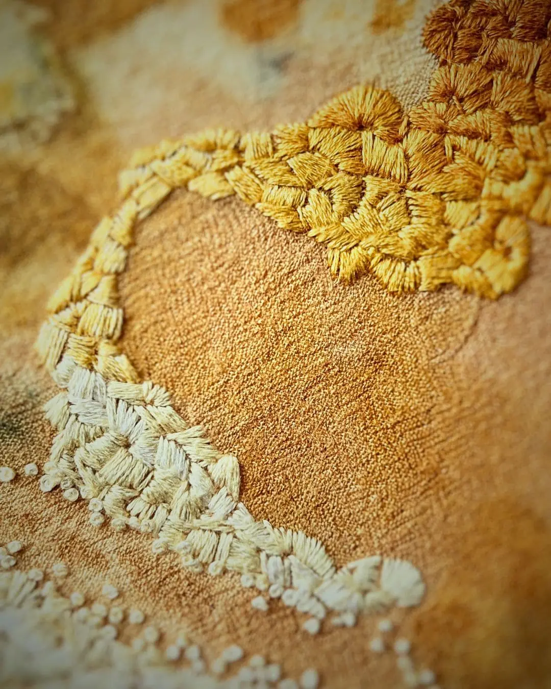 A close up of a stitched piece of fabric art