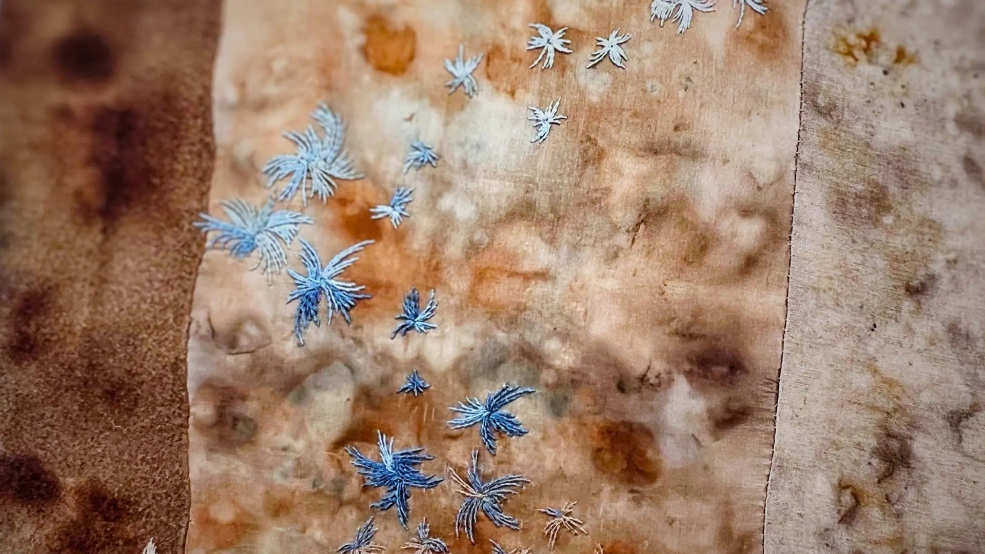 A close up of a stitched fabric artwork