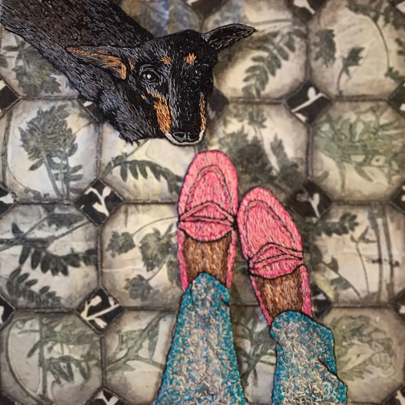 A stitched artwork of dog looking up and a pair of feet on a tile floor