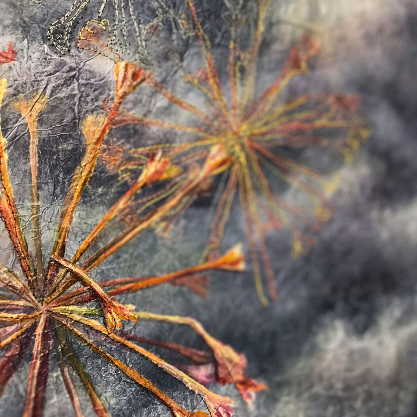 A close up of a stitched flower