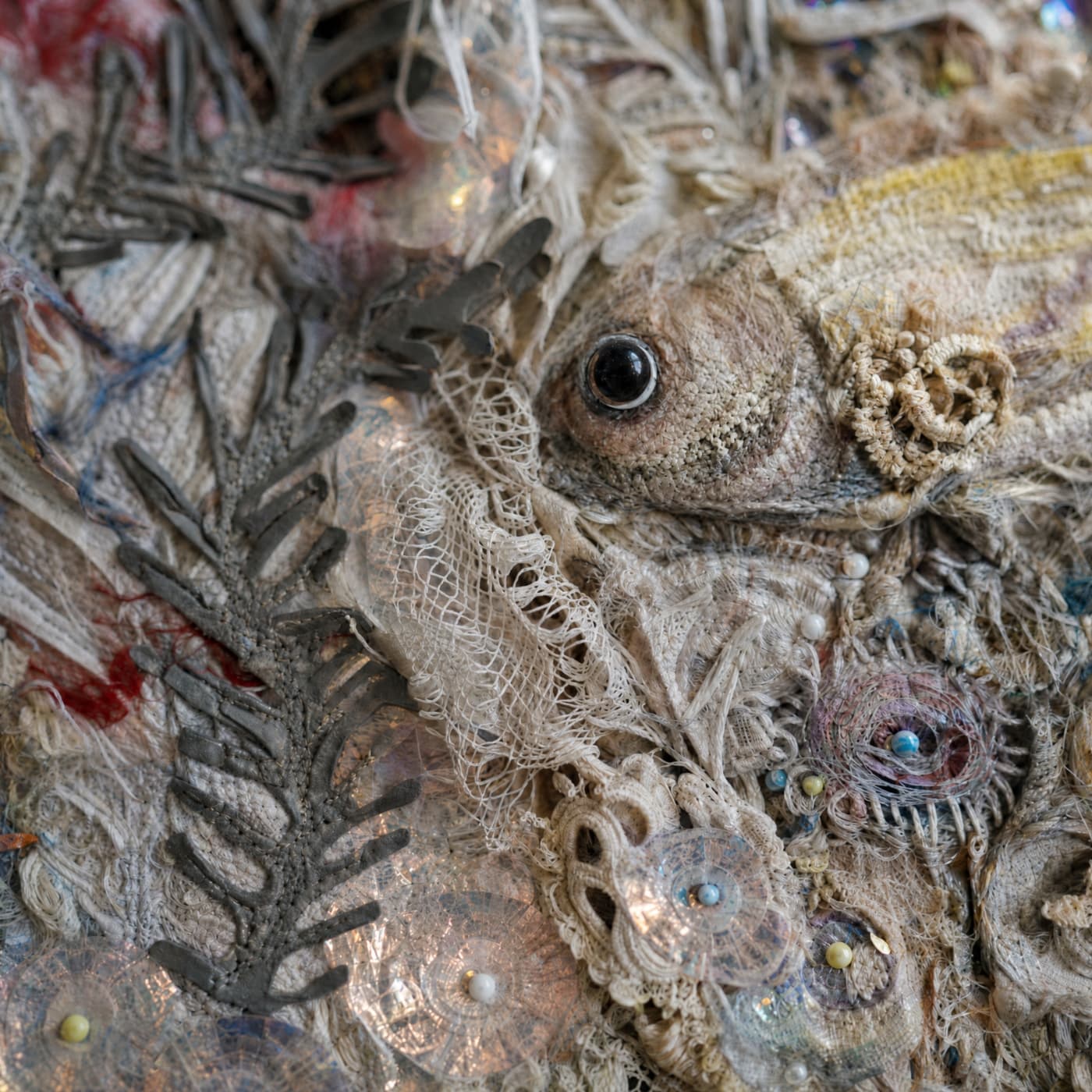 Textured artwork featuring fish and foliage.