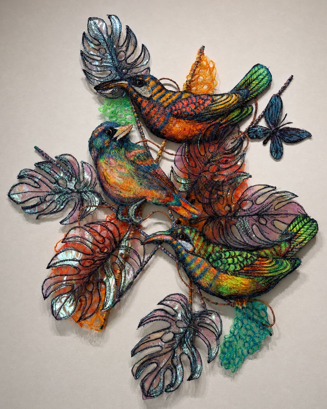 Colourful birds among vibrant foliage.