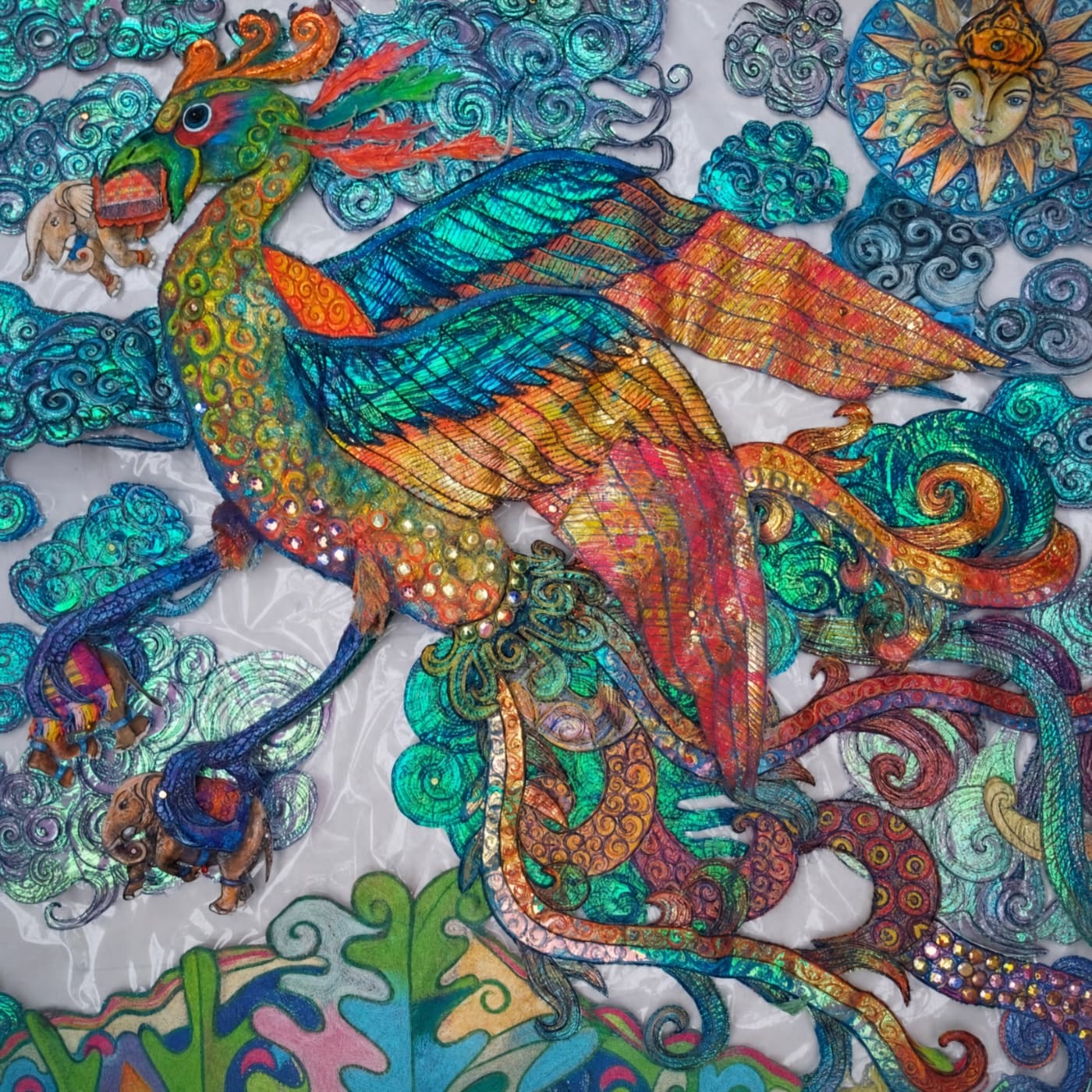 Vibrant mythical textile bird amidst colourful clouds.