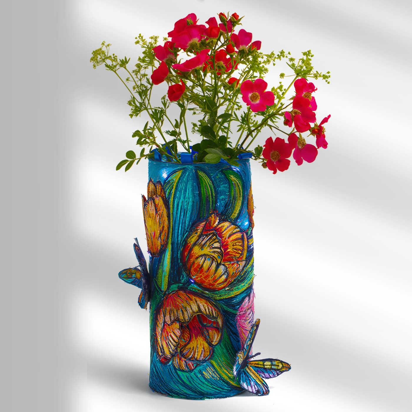 Colourful vase with vibrant flowers.