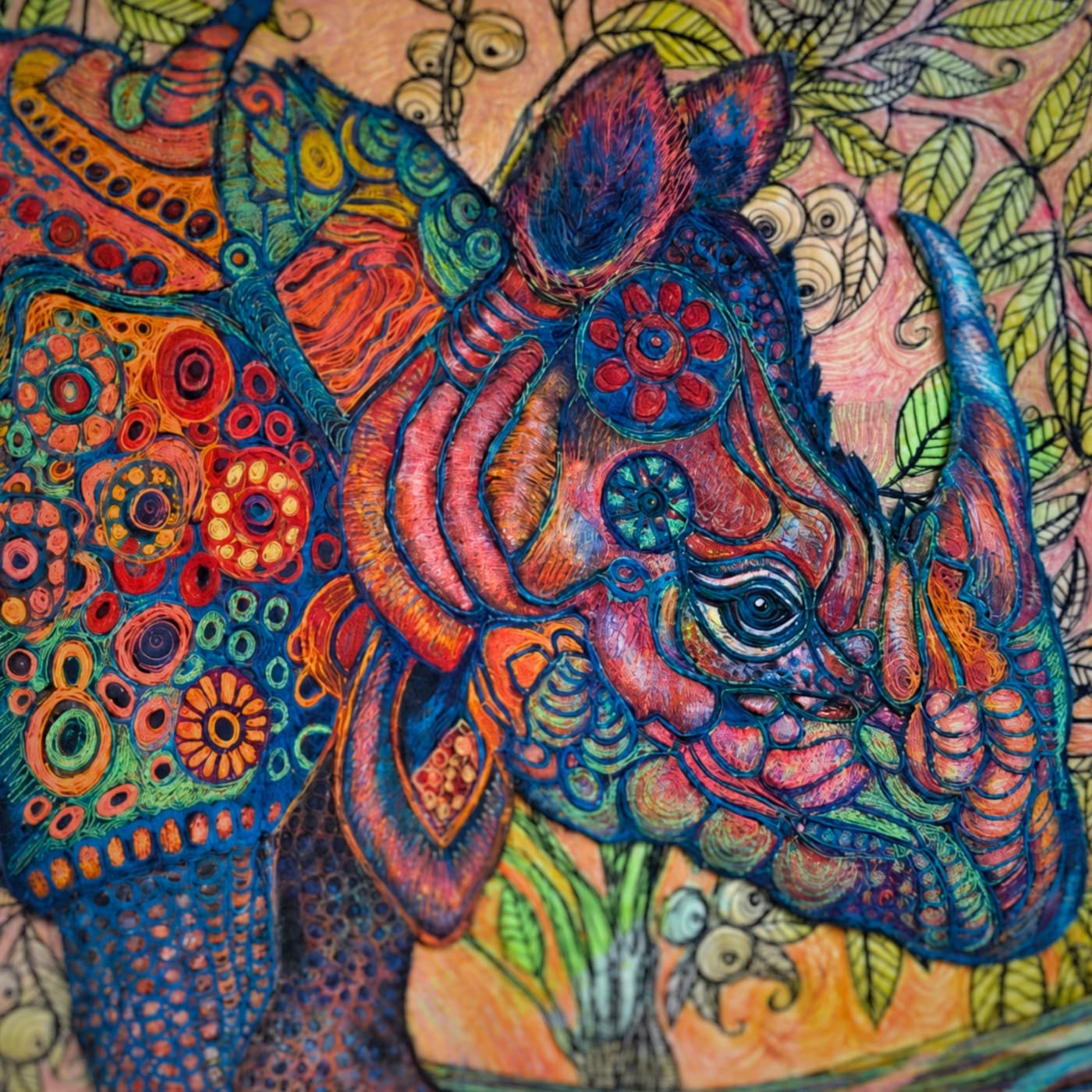 Colourful, intricate rhino textile piece.