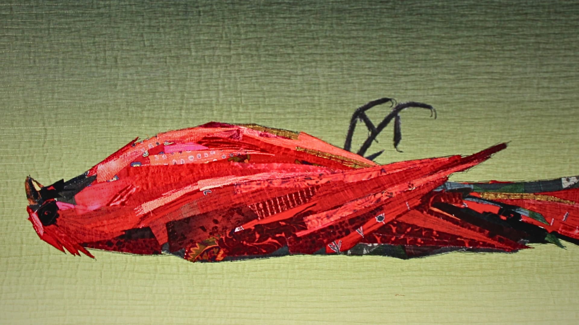 A red bird made textile art piece