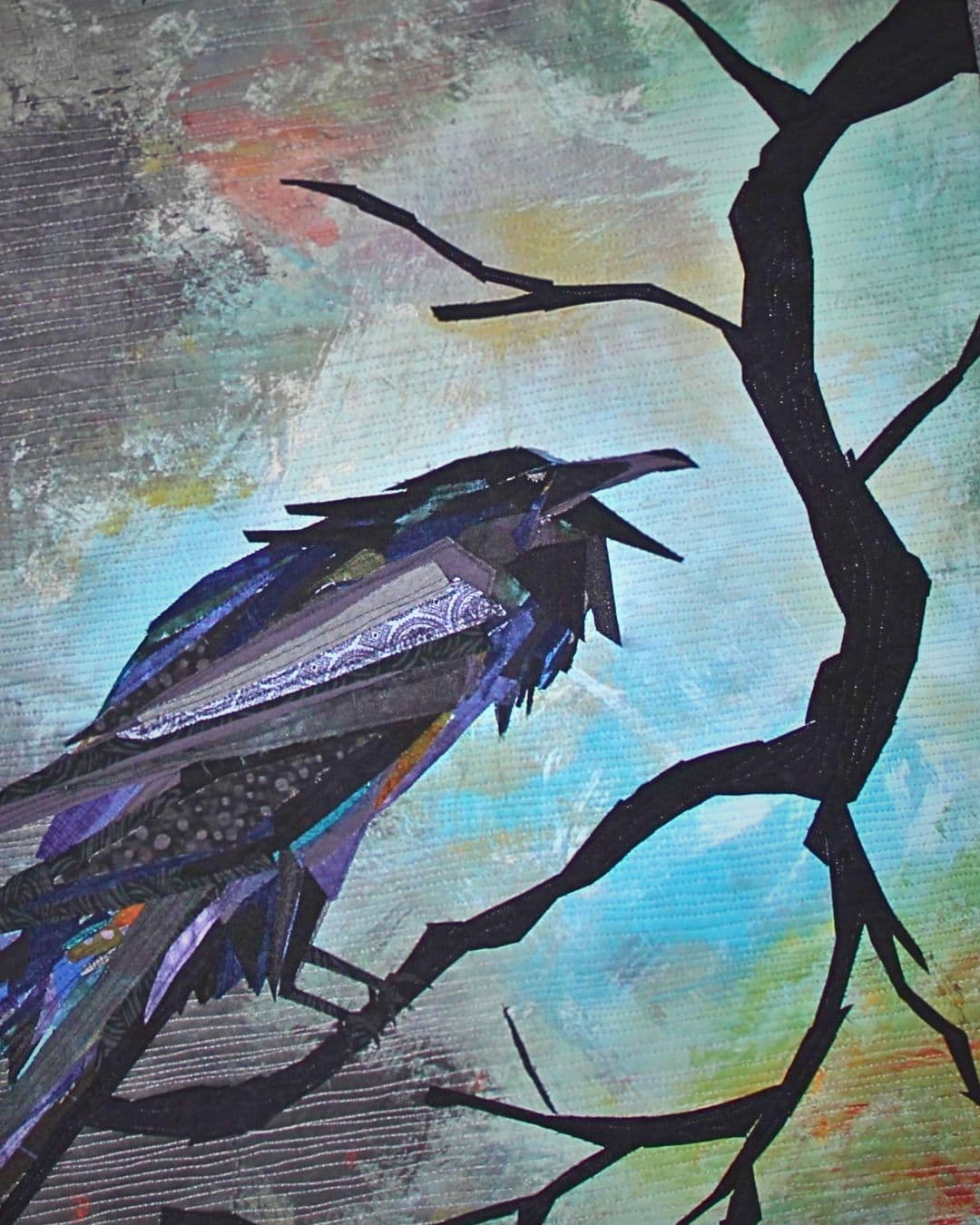 A fabric thread painting of a bird.