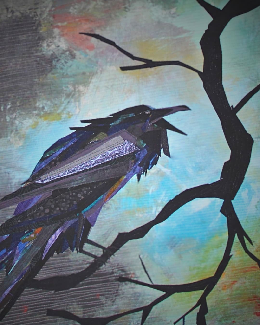 Stitched artwork of a bird on a tree branch