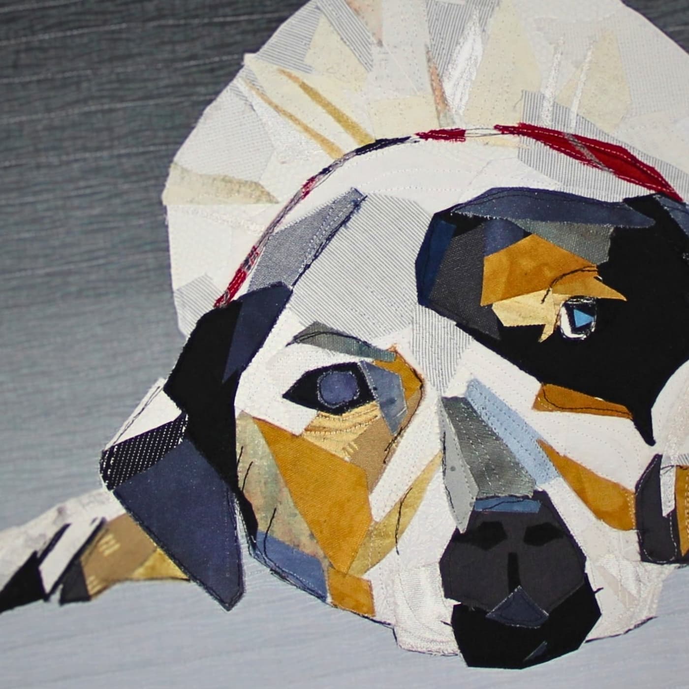 Stitched and quilted artwork of a dog