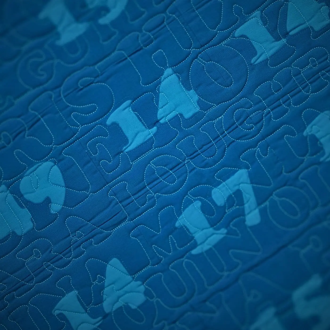 a blue art-quilt with light blue numbers