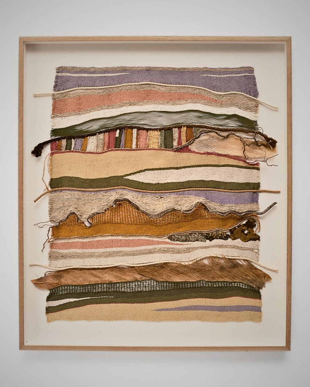 Handwoven textured artwork in earthy tones.