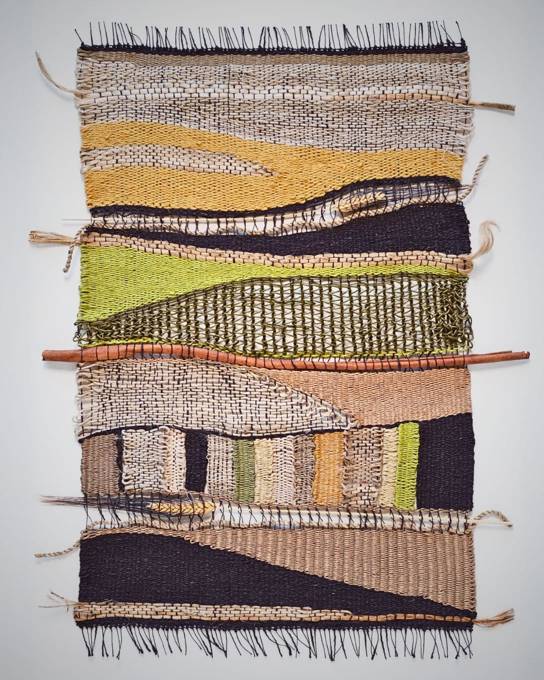 Handwoven textured artwork in earthy tones.