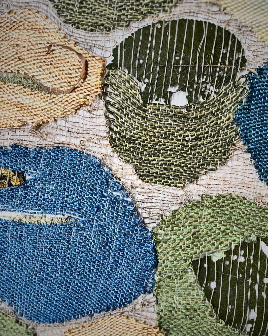 Handwoven textured fabric with colourful circular patterns.