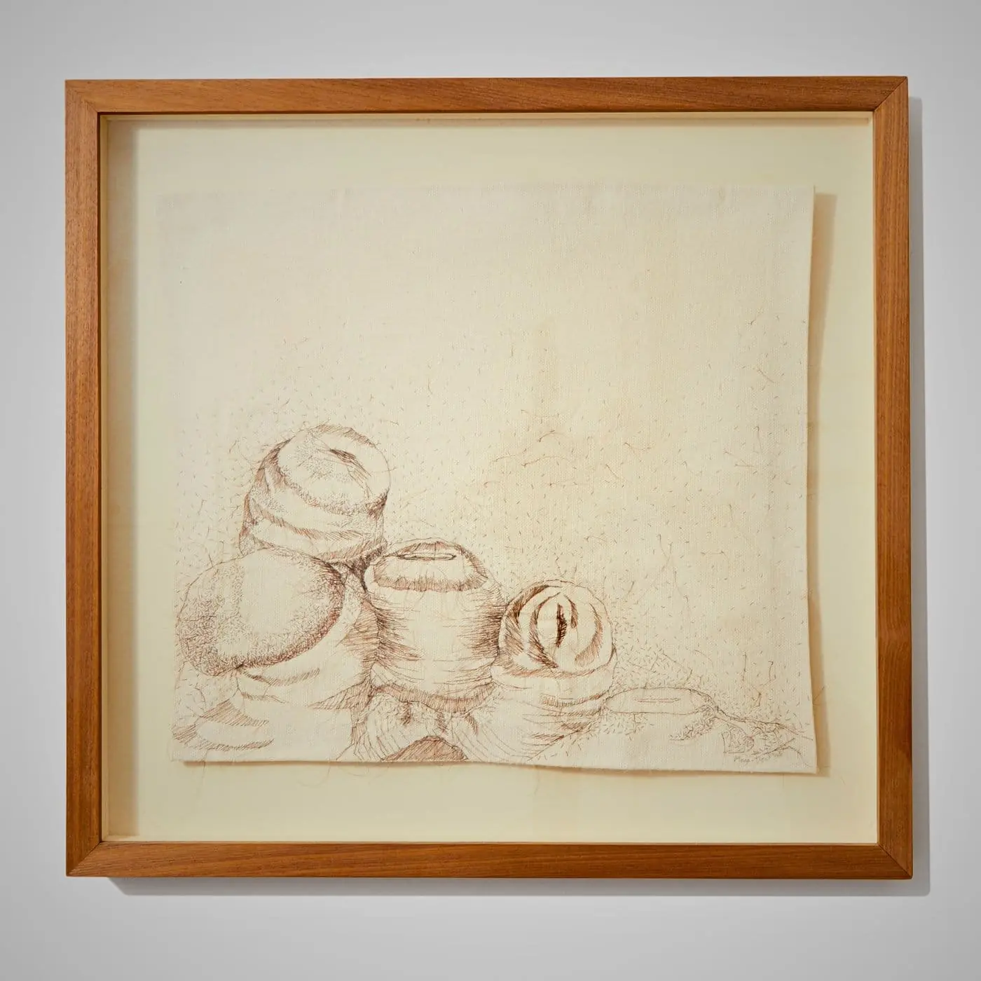 A hand stitched artwork in a frame
