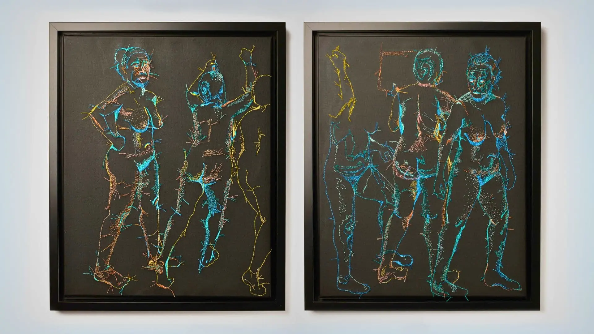 Two framed stitched artworks of nude women. Multicoloured stitches on a black background. 