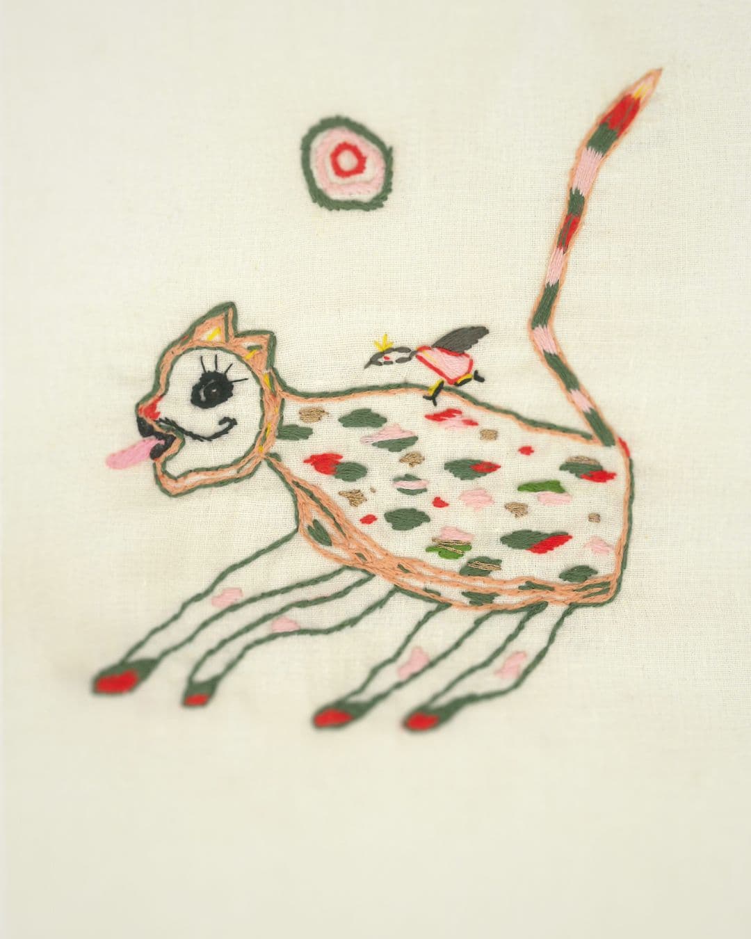 A print of a cat with a bird on its back