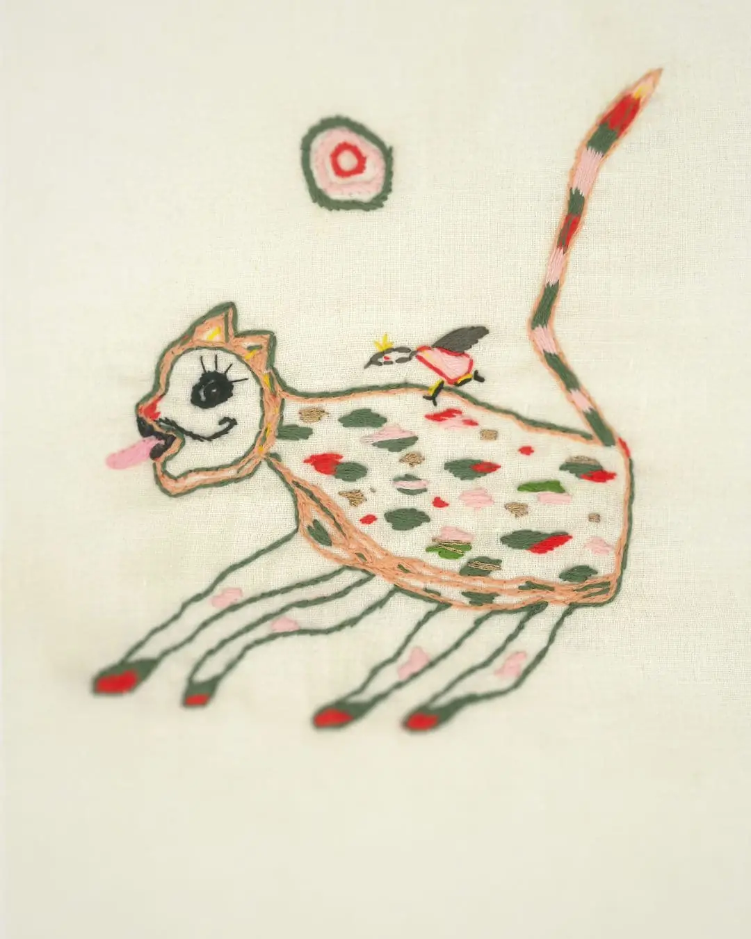 A print of a cat with a bird on its back