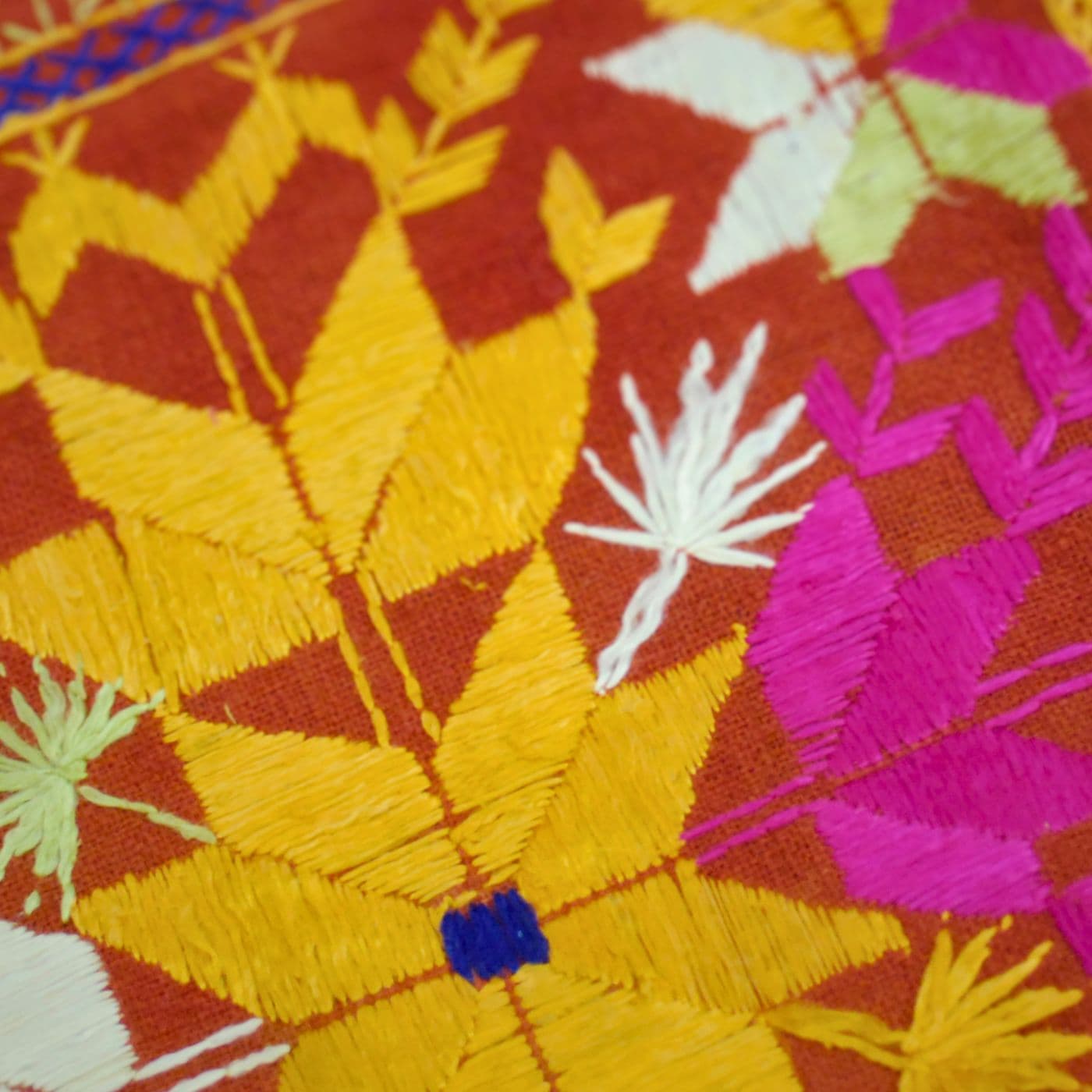 A colorful fabric with stitched flowers