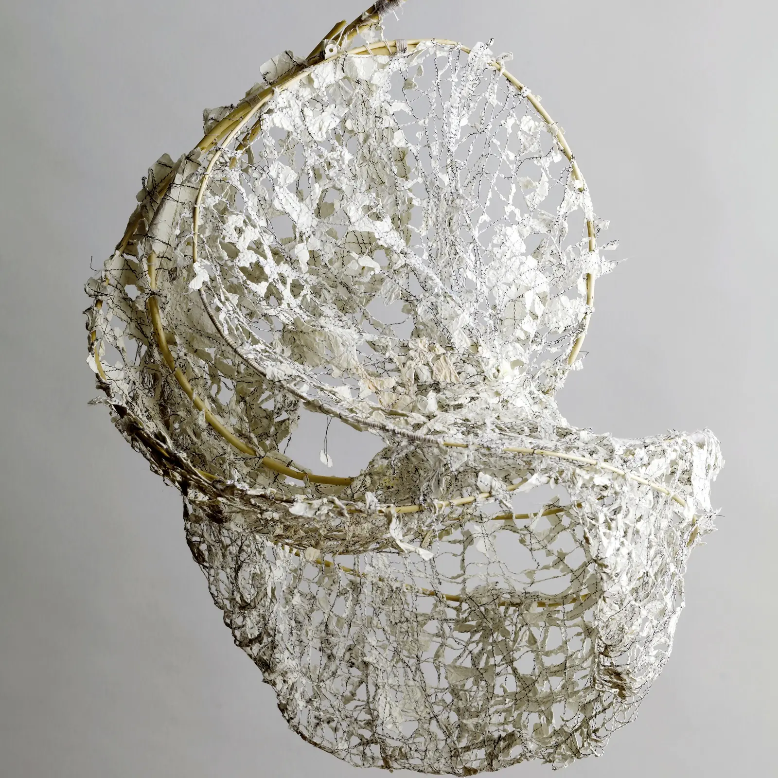 Siân Martin, Empty Nest, 2013. 40cm x 70cm (16" x 27½") Willow lengths, old school sketchbook pages. Steamed willow sculpture, disintegrated machine-stitched paper.