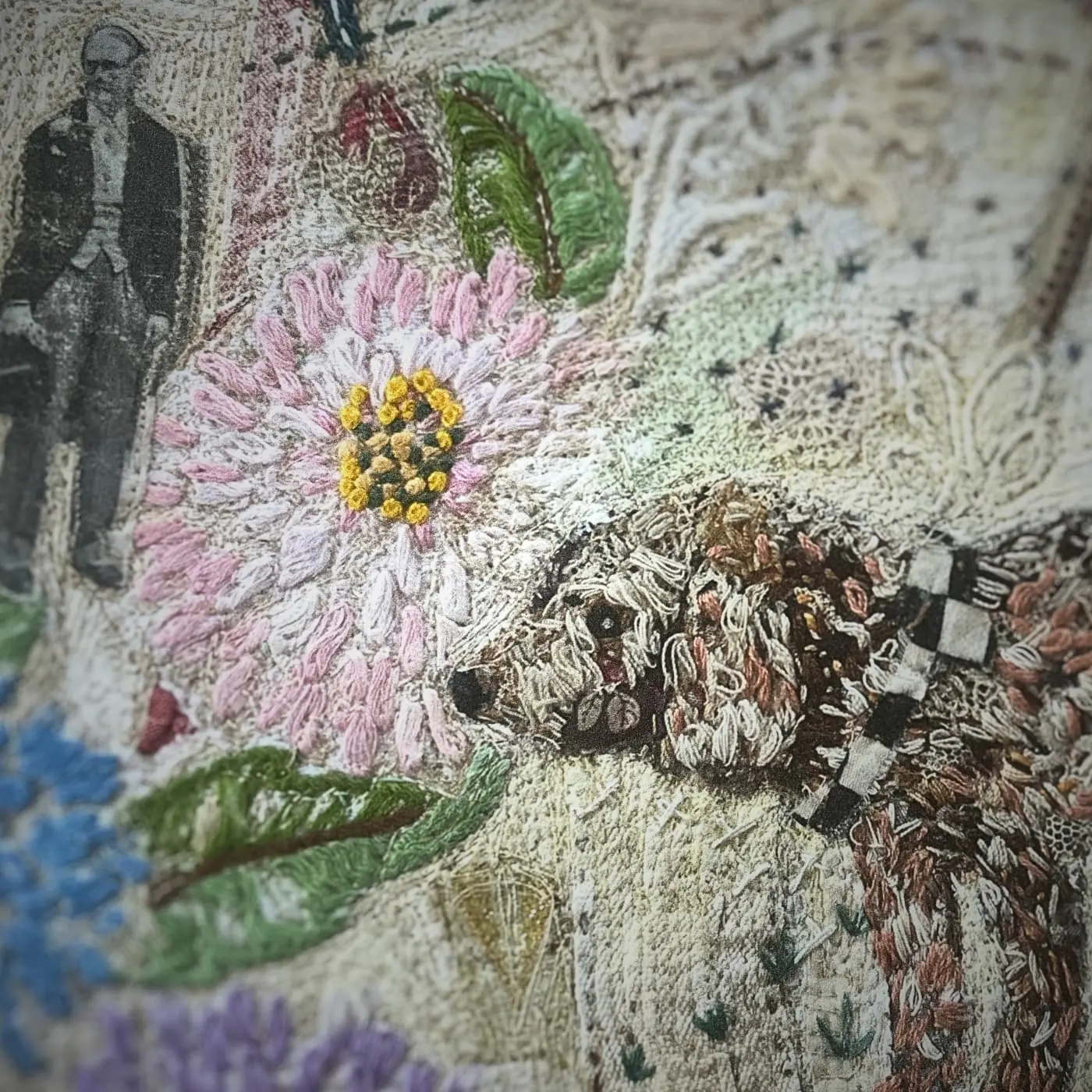 Embroidered dog among floral designs.