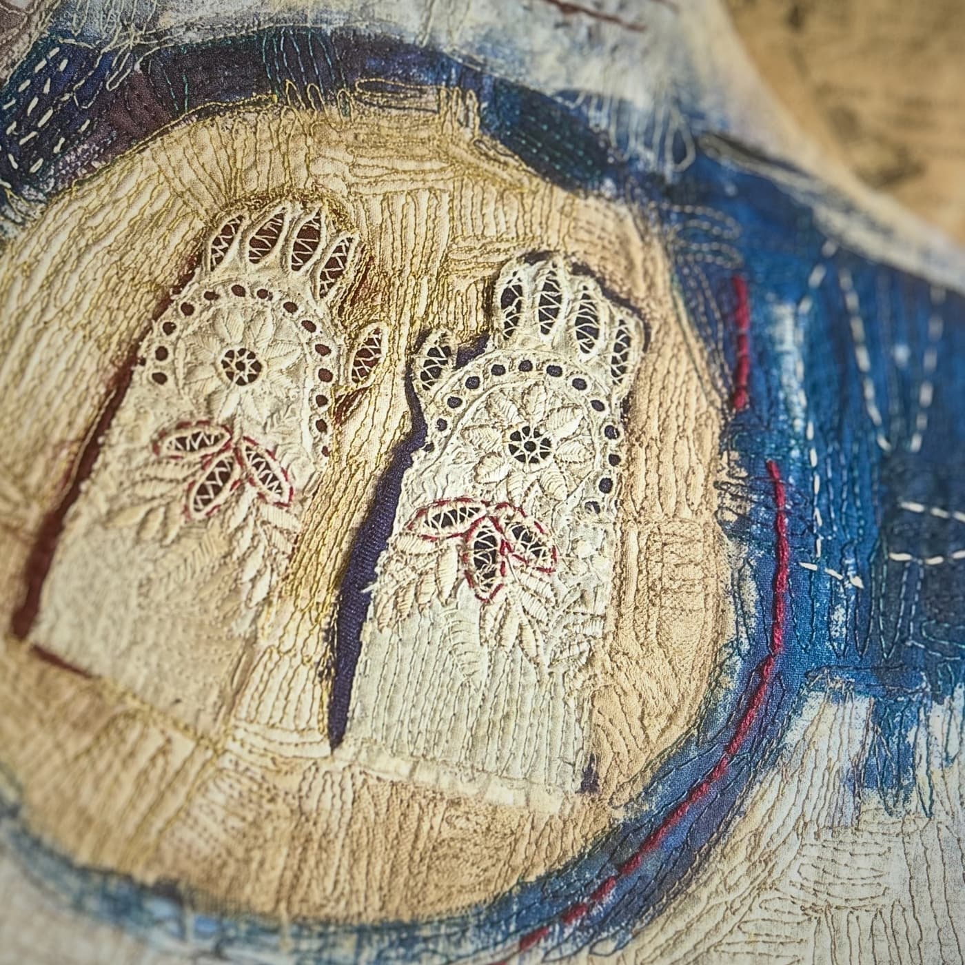 Intricate embroidered gloves on fabric