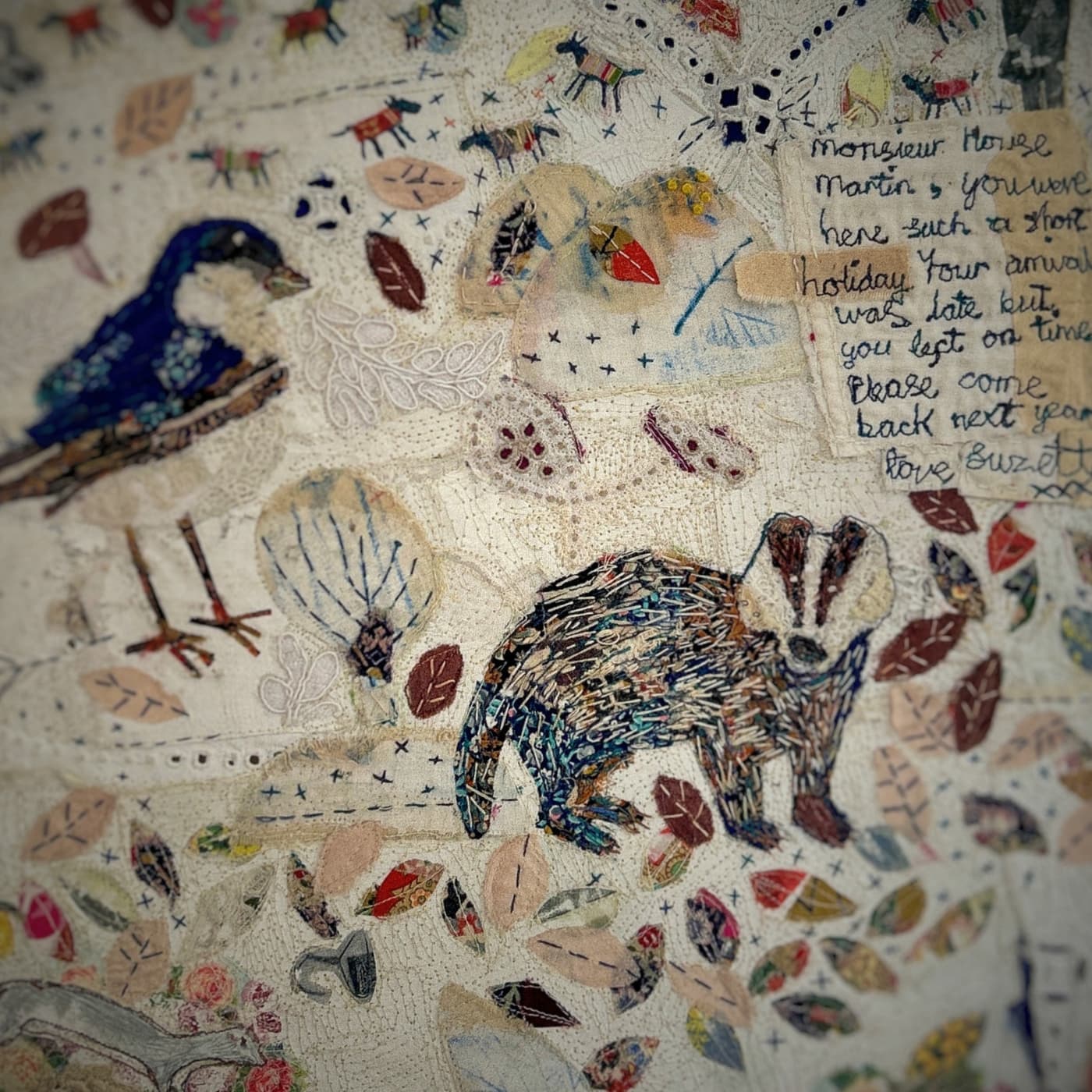 Embroidered wildlife and handwritten note.